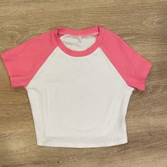 Halara Pink And White Ribbed Cropped Tee Shirt. Really Nice Stretch Material. It’s Cropped But Not Super Cropped. Can Be Worn As Athleisure To Work Out In But Looks Super Cute With Jeans! Size Large But Fits More Like A M/L Basic White Cotton Crop Top, White Basic Cotton Crop Top, White Crew Neck Cotton Crop Top, White Cotton Crew Neck Crop Top, Casual Crew Neck Crop Top With Color Block, Casual Color Block Crew Neck Crop Top, White Color Block Short Sleeve Top, Fitted White Color Block Top, Pink Color Block Short Sleeve Top