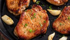 pork chops and potatoes cooking in a skillet