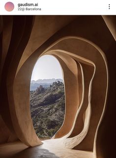 an arch in the side of a building with mountains in the background and sunlight coming through it