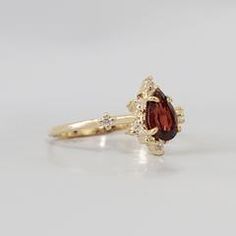 Heirloom Gold Garnet Rings, Gold Garnet Cluster Promise Ring, Heirloom Gold Cluster Ring With Garnet, Yellow Gold Garnet Promise Ring, Yellow Gold Garnet Diamond Promise Ring, Garnet Diamond Promise Ring In Yellow Gold, Gold Garnet Birthstone Ring With Center Stone, Yellow Gold Garnet Rings With Prong Setting, Fine Jewelry Gold Garnet Rings