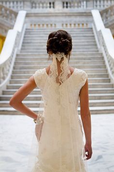 the back of a woman's dress in front of stairs