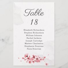 a table number card with pink flowers on it