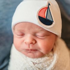 SpearmintLOVE’s baby Newborn Hat, Sailboat Playful White Beanie One Size, Playful White Beanie One Size Fits Most, Adjustable Soft White Beanie, Cute Soft White Hat, Playful White Cap Beanie, Playful White Beanie Cap, Playful White Adjustable Beanie, Casual White Beanie As Gift, Cute White Cotton Beanie