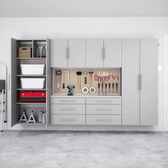 an organized garage with lots of storage and tools in the cabinet doors, along with other items