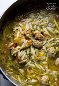 a pot filled with pasta and meatballs