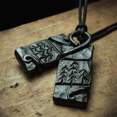 two black pendants sitting on top of a wooden table