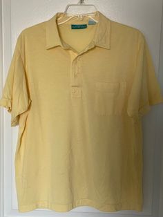 Very nice condition shirt from the 1980s by 615 Collection.  Very light yellow, almost sheer shirt in a very lightweight cotton/polyester blend great for the warmer weather.  The shirt has a pointed collar, four button placard and a left breast pocket.  Marked as a L Chest measures 21" (42 chest) Solid Color Summer Polo Shirt With Pockets, Summer Solid Polo Shirt With Pockets, Classic Spring Polo Shirt With Crew Neck, Classic Spring Crew Neck Polo Shirt, Classic Crew Neck Polo Shirt For Spring, Plain Yellow Top For Spring, Solid Polo Collar T-shirt For Spring, Yellow Polo Collar Shirt For Summer, Spring Solid Color Polo Collar T-shirt