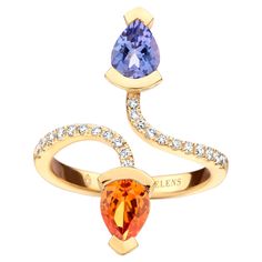 Adeline Duo ring in 18Kt yellow gold 5g set with a pear-shaped Tanzanite 0,70 Ct, a pear-shaped mandarin garnet 0,70 Ct and 0,19 Ct of white brilliant cut diamonds - VS F quality. Celine Roelens, a goldsmith and gemologist, is specialized in unique, fine jewelry, handmade in Belgium and brought to life by experienced craftsmen. Original pieces are made from precious materials of exceptional quality. When designing her creations, Celine resolutely opts for color. In this process, top-quality colored stones and durability are at the top of the list. A quest that takes her to the farthest corners of the world. Her finest tourmalines come from Madagascar, and her rarest sapphires from Sri Lanka. "All my jewelry designs revolve around color,” she explains passionately. The most beautiful specim Mandarin Garnet, Diamond Cocktail Ring, Diamond Cocktail Rings, Cocktail Ring, Jewelry Handmade, Brilliant Cut Diamond, Cocktail Rings, Tanzania, Madagascar