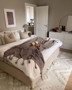 a large bed sitting in a bedroom on top of a white rug