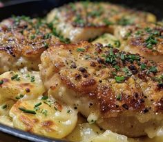 some meat and potatoes in a pan with parsley on the top, ready to be eaten