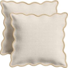 two white pillows with scalloped edges on each side, one in cream and the other in beige