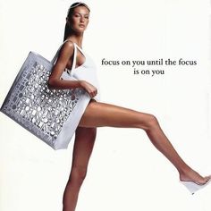 a woman is holding a shopping bag and posing for a magazine advert with the caption focus on you until the focus is on you