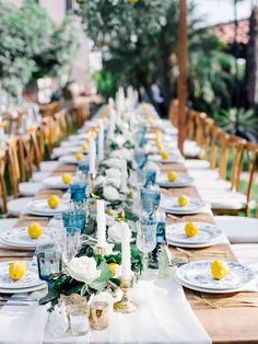 a long table is set with white and blue plates