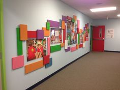 an office hallway decorated with colorful pictures and magnets