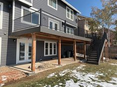 a house that has some stairs in front of it and snow on the ground outside