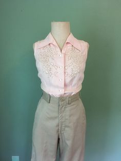 "1940s handmade blouse pink, lightweight cotton sleeveless Mother Of Pearl buttons lace front detail waist darts up front bust darts from side slanted up beautiful long collar pointed down good vintage condition w/wear- patched and mended by me(see last 3 pictures) measures, lying flat, shoulder-13\" chest-17\" waist-14\" hem-18\" length-23\"     We do not offer returns or refunds unless something is grossly misrepresented. Please contact us within 2 business days of receiving to discuss any possible returns for this reason. We do not offer refunds for your shipping fees. Please feel free to contact us with any questions you may have about an item prior to purchase and we will gladly answer them." Fitted Collar Blouse For Summer, Fitted Pink Shirt For Daywear, Feminine Fitted Collared Top, Fitted Sleeveless Blouse For Spring, Vintage Lace Collar Button-up Top, Cotton Button-up Tops With Lace Collar, Fitted Cotton Shirt With Lace Trim, Spring Vintage Button-up Tops, Fitted Sleeveless Blouse With Button Closure