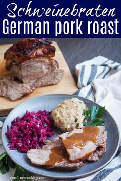 a plate with meat, coleslaw and gravy on it next to a cutting board