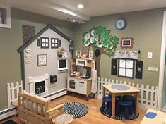 a child's playroom with furniture and decor