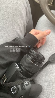 a person holding a camera in their lap