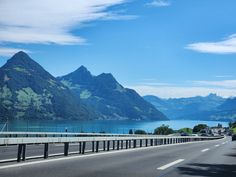 an empty highway with mountains in the background