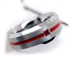 a red and silver ring with a cross on it