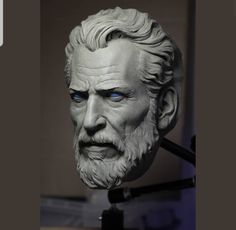 a statue of an old man with blue eyes