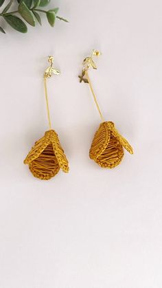 Add a pop of color to your wardrobe with these handmade lightweight yellow raffia tulip earrings. These boho chic statement jewelry pieces are perfect for adding a fun and unique touch to any outfit. The intricate tulip design is sure to catch the eye and elevate your look. Made from high-quality raffia material, these earrings are not only stylish but also comfortable to wear all day long. Whether you're headed to a music festival or a night out with friends, these earrings are the perfect acce Chic Handmade Earrings For Spring, Handmade Yellow Earrings For Spring, Chic Yellow Earrings For Spring, Elegant Woven Earrings For Spring, Yellow Earrings For Beach In Spring, Handmade Yellow Flower Earrings For Beach, Yellow Handmade Flower Earrings, Raffia Jewelry, Tulip Earrings