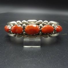 "VINTAGE NAVAJO BRACELET DESCRIPTION: This radiant bracelet features 11 gorgeous specimens of old red Mediterranean coral, which completely fill the cuff from end to end. The gemstones are secure in sawtooth bezel, on a foundation of heavy gauge vintage sterling silver. This bracelet will be a cherished addition to your collection of fine vintage Native American jewelry. MEASUREMENTS: Interior of the cuff measures 5 1/4\" with an additional 1 1/8\" non-adjustable gap. Total circumference: 6 3/8\ Classic Red Bangle Jewelry, Vintage Handmade Red Bangle, Classic Handmade Cuff Bracelet Collectible, Red Vintage Bangle For Wedding, Vintage Red Jewelry With Jubilee Bracelet, Red Vintage Jewelry With Jubilee Bracelet, Vintage Red Jubilee Bracelet, Vintage Red Bracelets For Anniversary, Vintage Red Bracelets For Wedding