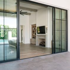 a living room with glass doors and a fireplace