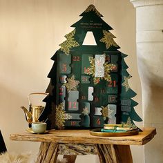 a christmas tree shaped calendar sitting on top of a wooden table