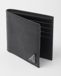 Enameled metal triangle logo Eight card slots Two bill compartments Moire and Saffiano leather lining Modern Bifold Wallet With Logo Plaque, Modern Black Wallet With Logo Plaque, Black Business Wallet With Logo Plaque, Luxury Leather Wallet With Silver-tone Logo, Designer Business Trifold Wallet, Designer Business Wallet With Logo Plaque, Classic Leather Wallet With Logo Plaque, Luxury Formal Wallets With Silver-tone Logo, Classic Leather Wallets With Logo Plaque