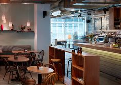 the interior of a restaurant with tables and chairs