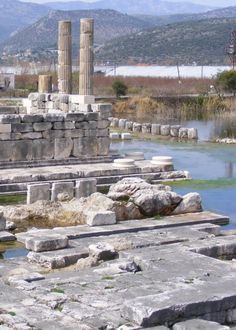 the ruins are surrounded by water and mountains