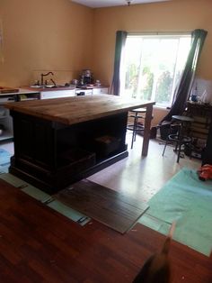 an open kitchen and living room with hardwood floors