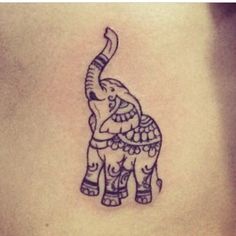 an elephant tattoo on the back of a woman's stomach