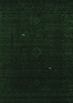 a green area rug with squares and dots on it