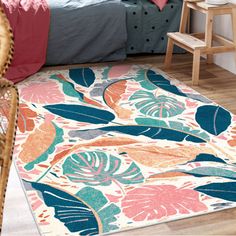 an area rug with tropical leaves on it