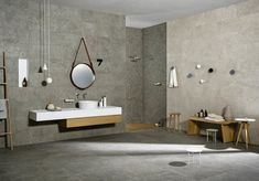 a bathroom with two sinks and mirrors on the wall