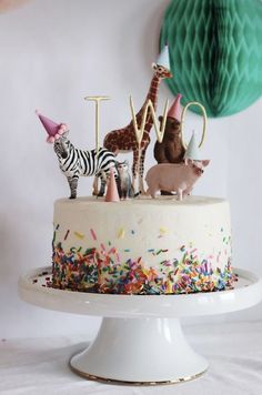 an instagram page with a cake decorated like animals and letters that spell out the word love