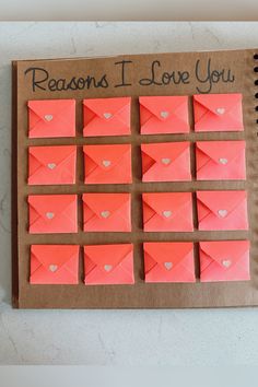 an envelope with hearts is displayed on a bulletin board that says, reason i love you