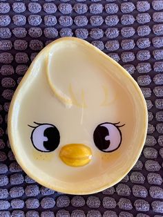 a yellow plate with an angry bird face on it