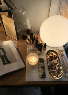 a table topped with lots of different types of makeup and hair brushes on top of it