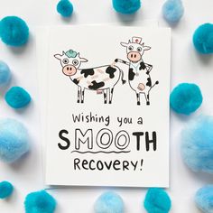 a card that says wishing you a smooth recovery with blue pom - poms around it