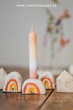 a lit candle sitting on top of white rocks