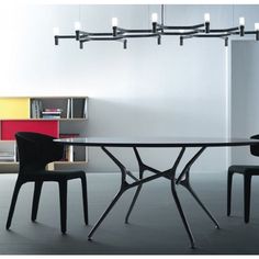 a modern dining table with four chairs around it