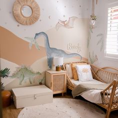 a child's bedroom decorated with dinosaur wallpaper