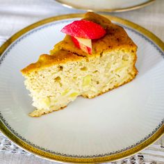 a piece of cake on a plate with a bite taken out of it and a bowl in the background