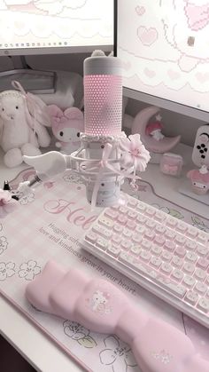 a desk with a keyboard, mouse and stuffed animals on it