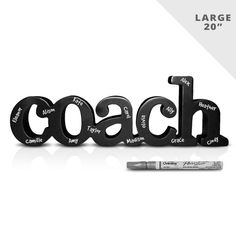 the word coach written in black letters next to a marker and pen on a white background