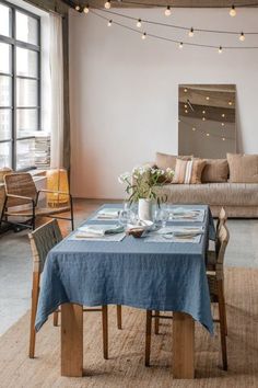 a living room with a couch, table and chairs